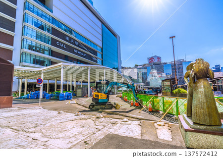 Yokohama cityscape, Japan, March 11. Work is underway to repair the damaged sidewalk at the west exit of Yokohama Station. Materials, heavy machinery, and waste are lined up. 137572412