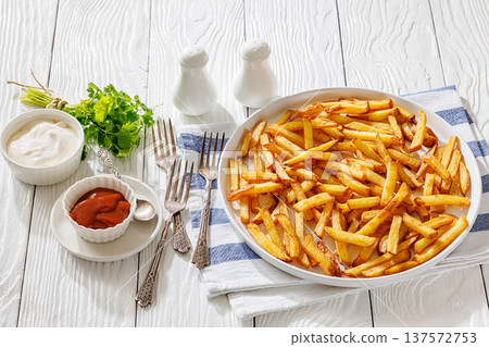 Plate of crispy golden french fries, top view Plate of crispy golden french fries, top view 137572753