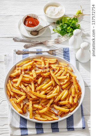 Plate of crispy golden french fries, top view Plate of crispy golden french fries, top view 137572754