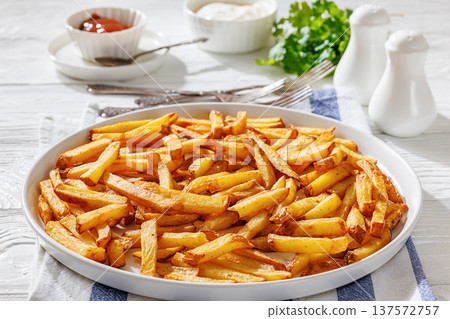 Plate of crispy golden french fries, top view Plate of crispy golden french fries, top view 137572757