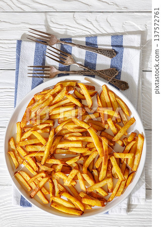 Plate of crispy golden french fries, top view Plate of crispy golden french fries, top view 137572761