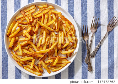 Plate of crispy golden french fries, top view 137572762