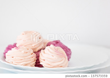 blackcurrant and apple zephyr on white plate blackcurrant and apple zephyr on white plate 137573359