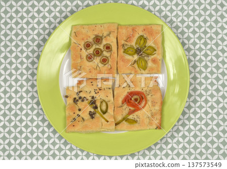 Assorted Artistic Focaccia Slices with Vegetable Designs 137573549