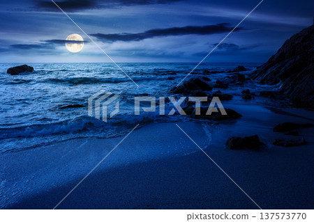 mysterious sandy sea beach at night. full moon over scene on cold summer vacation season. beautiful view of waves washing the sand. generic image of seascape and sky for advertising background 137573770