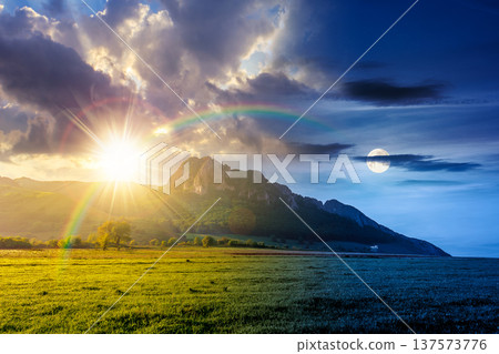rock formation near green field. day meet night. sun and moon over beautiful rural landscape in mountains. wonderful scenery lush grass in spring. cloudy sky. alpine countryside outdoor adventure rock formation near green field. day meet night. sun and moon over beautiful rural landscape in mountains. wonderful scenery lush grass in spring. cloudy sky. alpine countryside outdoor adventure 137573776