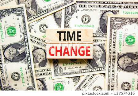 Time change symbol. Concept word Time change on beautiful wooden blocks. Dollar bills. Beautiful dollar bills background. Business time change concept. Copy space. Time change symbol. Concept word Time change on beautiful wooden blocks. Dollar bills. Beautiful dollar bills background. Business time change concept. Copy space. 137574316