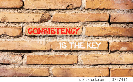 Consistency is the key symbol. Concept words Consistency is the key on beautiful brick wall. Beautiful brick wall background. Business consistency is the key concept. Copy space. Consistency is the key symbol. Concept words Consistency is the key on beautiful brick wall. Beautiful brick wall background. Business consistency is the key concept. Copy space. 137574341