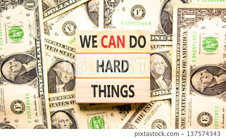 Support, help we can do hard things symbol. Concept words We can do hard things on beautiful wooden blocks. Beautiful dollar bills background. Business we can do hard things concept. Copy space. Support, help we can do hard things symbol. Concept words We can do hard things on beautiful wooden blocks. Beautiful dollar bills background. Business we can do hard things concept. Copy space. 137574343