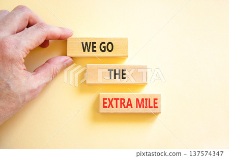 Support, help we go the extra mile symbol. Concept words We go the extra mile on beautiful wooden blocks. Beautiful white background. Business we go the extra mile concept. Copy space. Support, help we go the extra mile symbol. Concept words We go the extra mile on beautiful wooden blocks. Beautiful white background. Business we go the extra mile concept. Copy space. 137574347