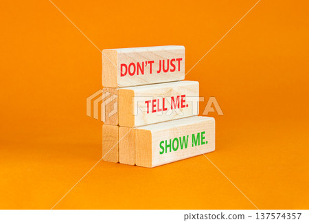 Tell or show symbol. Concept words Do not just tell me, show me on beautiful wooden blocks. Beautiful orange background. Business tell or show concept. Copy space. Tell or show symbol. Concept words Do not just tell me, show me on beautiful wooden blocks. Beautiful orange background. Business tell or show concept. Copy space. 137574357