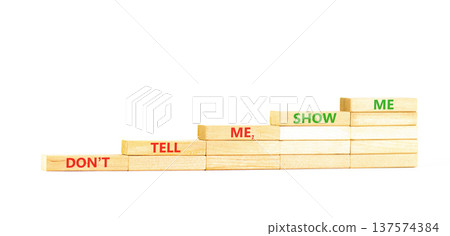 Tell or show symbol. Concept words Do not tell me, show me on beautiful wooden blocks. Beautiful white paper background. Business tell or show concept. Copy space. 137574384