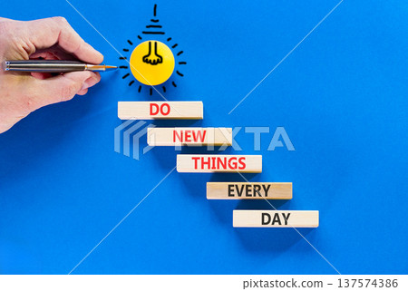 Do new things every day words symbol. Concept words Do new things every day on beautiful wooden blocks. Beautiful blue background. Light bulb icon. Business do new things every day concept. Copy space 137574386