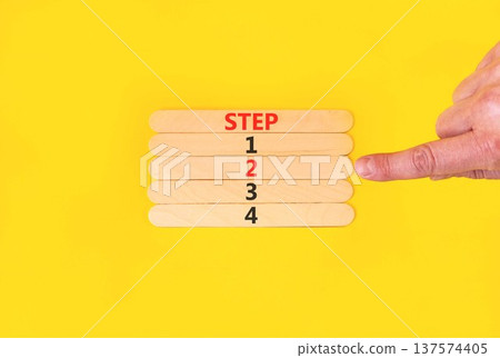 Time to step 2 symbol. Concept word Step 1 2 3 4 on beautiful wooden sticks. Businessman's hand. Beautiful yellow background. Business planning and time to Step 2 concept. Copy space. Time to step 2 symbol. Concept word Step 1 2 3 4 on beautiful wooden sticks. Businessman's hand. Beautiful yellow background. Business planning and time to Step 2 concept. Copy space. 137574405