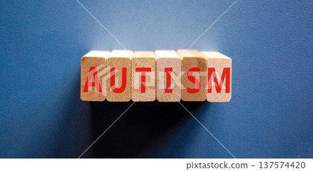 Autism medical symbol. Concept word Autism on beautiful wooden blocks. Beautiful blue background. Business autism medical concept. Copy space. Autism medical symbol. Concept word Autism on beautiful wooden blocks. Beautiful blue background. Business autism medical concept. Copy space. 137574420