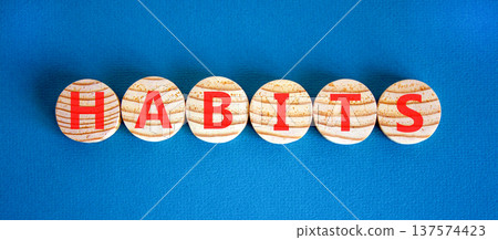 Habits support and help symbol. Concept word Habits on beautiful wooden circles. Beautiful blue background. Business psychological habits support and help concept. Copy space. Habits support and help symbol. Concept word Habits on beautiful wooden circles. Beautiful blue background. Business psychological habits support and help concept. Copy space. 137574423