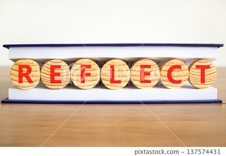 Reflect word symbol. Concept word Reflect on beautiful wooden circles in book. Beautiful wooden table white background. Business psychological reflect word concept. Copy space. Reflect word symbol. Concept word Reflect on beautiful wooden circles in book. Beautiful wooden table white background. Business psychological reflect word concept. Copy space. 137574431
