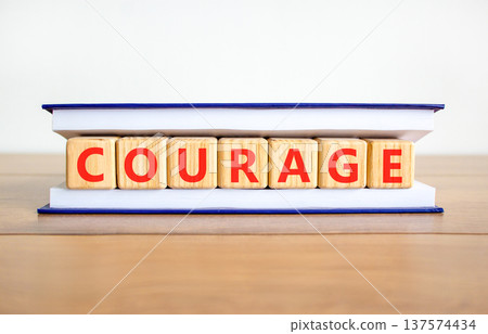 Courage symbol. Concept word Courage on beautiful wooden blocks in book. Beautiful wooden table white background. Business courage concept. Copy space. Courage symbol. Concept word Courage on beautiful wooden blocks in book. Beautiful wooden table white background. Business courage concept. Copy space. 137574434