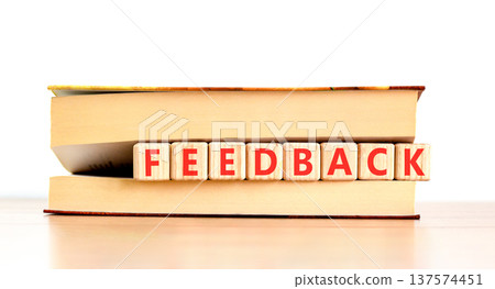 Feedback word symbol. Concept word Feedback on beautiful wooden blocks in beautiful book. Beautiful wooden table white background. Business support help feedback word concept. Copy space. Feedback word symbol. Concept word Feedback on beautiful wooden blocks in beautiful book. Beautiful wooden table white background. Business support help feedback word concept. Copy space. 137574451