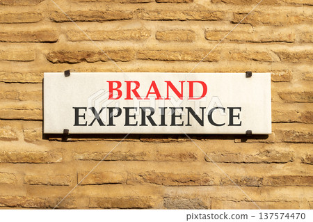 Brand experience symbol. Concept words Brand experience on beautiful big white sign plate. Beautiful old brown brick wall background. Business branding and brand experience concept. Copy space. Brand experience symbol. Concept words Brand experience on beautiful big white sign plate. Beautiful old brown brick wall background. Business branding and brand experience concept. Copy space. 137574470