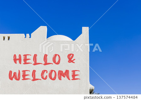 Hello and welcome symbol. Concept words Hello and welcome on beautiful white wall. Beautiful white wall and blue sky background. Business hello and welcome concept. Copy space. Hello and welcome symbol. Concept words Hello and welcome on beautiful white wall. Beautiful white wall and blue sky background. Business hello and welcome concept. Copy space. 137574484