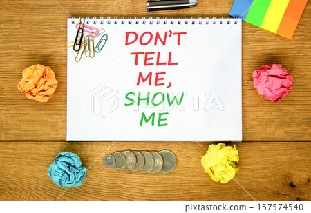 Tell or show symbol. Concept words Do not tell me, show me on beautiful white note. Beautiful wooden background. Colored paper. Black pen. Business tell or show concept. Copy space. 137574540