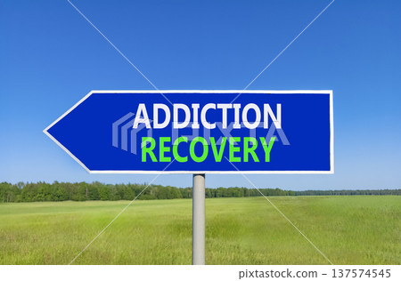Addiction recovery symbol. Concept words Addiction recovery on beautiful blue road sign. Beautiful blue sky green grass field background. Psychology addiction recovery concept. Copy space. Addiction recovery symbol. Concept words Addiction recovery on beautiful blue road sign. Beautiful blue sky green grass field background. Psychology addiction recovery concept. Copy space. 137574545