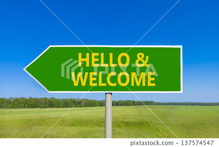Hello and welcome symbol. Concept words Hello and welcome on beautiful green road sign. Beautiful blue sky green grass field background. Business hello and welcome concept. Copy space. Hello and welcome symbol. Concept words Hello and welcome on beautiful green road sign. Beautiful blue sky green grass field background. Business hello and welcome concept. Copy space. 137574547