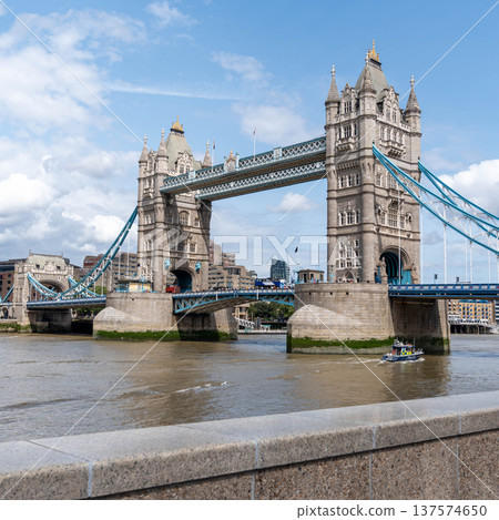 Tower Bridge crossing the River Thames with the London city skyline forming an urban river landscape scene. Tower Bridge crossing the River Thames with the London city skyline forming an urban river landscape scene. 137574650