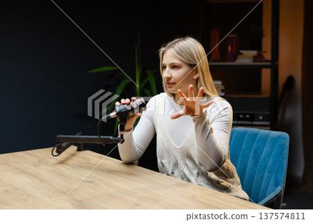 Excited female podcaster celebrating success in her home studio Excited female podcaster celebrating success in her home studio 137574811