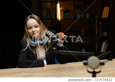 Radio host speaking with microphone and headphones in a recording studio Radio host speaking with microphone and headphones in a recording studio 137574812
