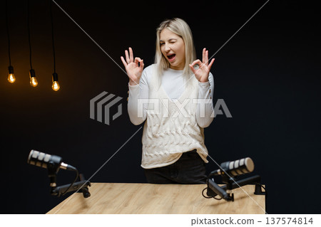 Podcaster gesturing ok sign during recording podcast Podcaster gesturing ok sign during recording podcast 137574814