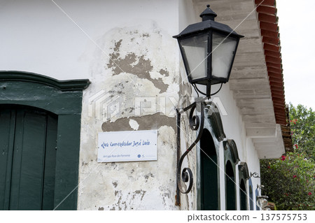 Street sign and vintage lantern on a colonial wall in Paraty Street sign and vintage lantern on a colonial wall in Paraty 137575753