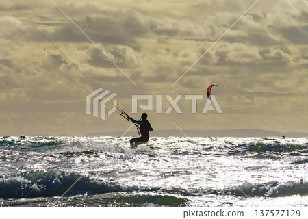 Kite surfer riding waves. Kiteboarding sport. Kite surfer riding waves. Kiteboarding sport. 137577129