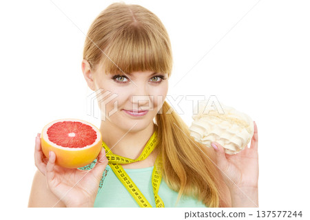 Woman choosing fruit or cake make dietary choice 137577244