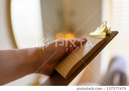 Hand holding a clipboard Hand holding a clipboard 137577479