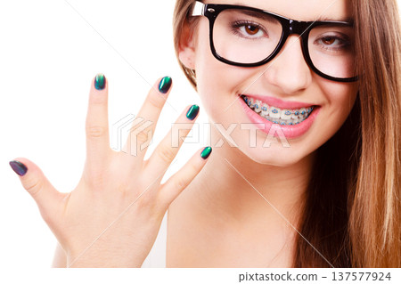Happy nerdy teenage with brace wearing eyeglasses 137577924