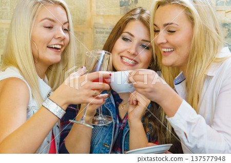 Girls with alcohol glass in pub club Girls with alcohol glass in pub club 137577948