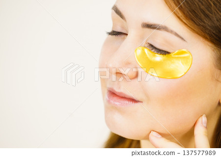 Woman with gold patches under eyes 137577989