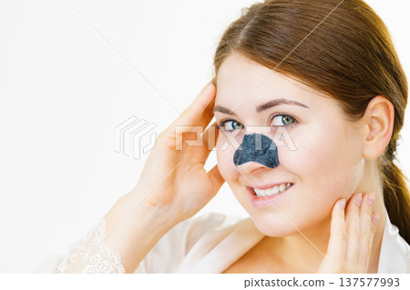 Woman applying pore strips on nose 137577993