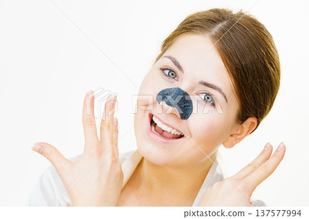 Woman applying pore strips on nose 137577994