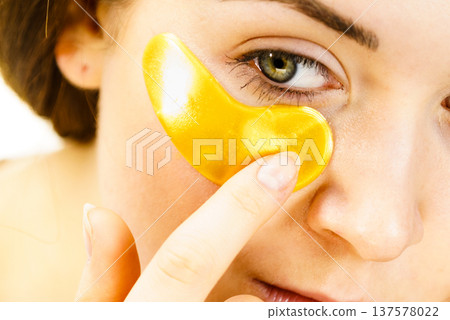 Woman with gold patches under eyes 137578022