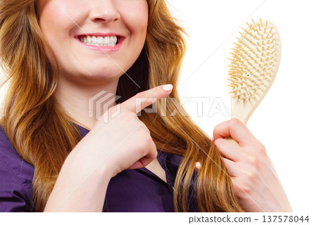 Woman brushing long healthy brown hair 137578044