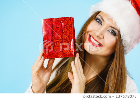 Happy Christmas woman holds red gift bag Happy Christmas woman holds red gift bag 137578073