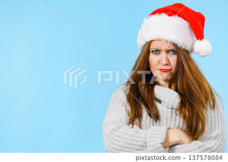 Tired woman wearing santa hat Tired woman wearing santa hat 137578084