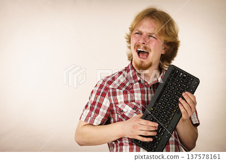 Gamer man holding computer keyboard Gamer man holding computer keyboard 137578161