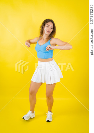 Young woman dancing with energy and happy expression Young woman dancing with energy and happy expression 137578283
