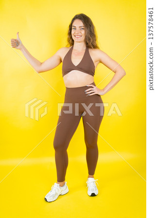 Smiling woman giving thumbs up approving healthy lifestyle 137578461