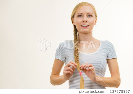 Blonde young woman with braid hair Blonde young woman with braid hair 137578537