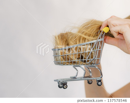 Girl with her long hair in shopping cart Girl with her long hair in shopping cart 137578546